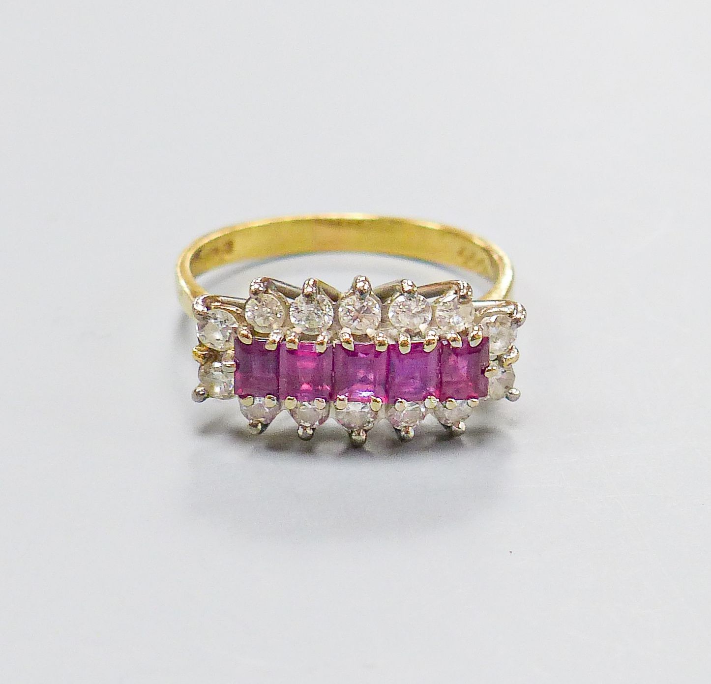 A modern 18ct gold, ruby and diamond half hoop cluster ring, size Q, gross weight 4.5 grams.
